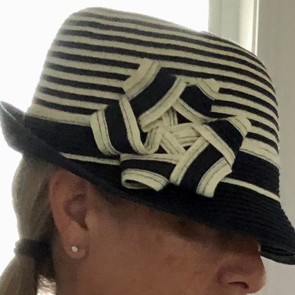 Fedora style, blue and white stripped hat with detailed bow. Adjustable.